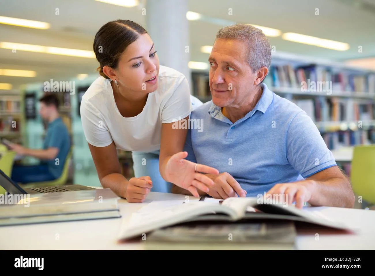 help-the-elderly-in-the-public-library-young-volunteers-help-elderly-3djf82k Unexpected acts of kindness trigger emotional warmth that our brains naturally prioritize for longterm memory